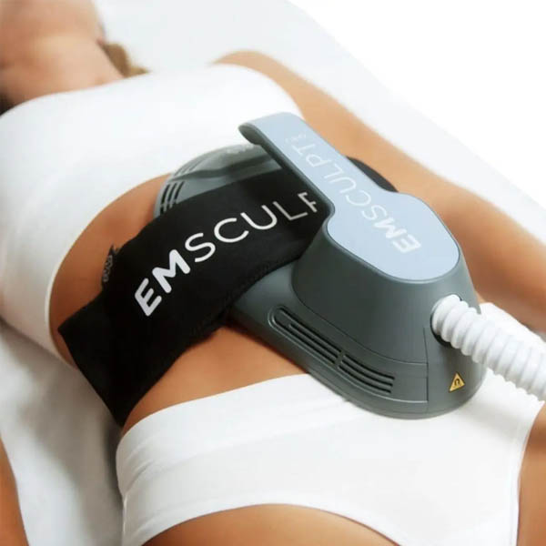 Client receiving external muscle stimulation during a Leeds EMSculpt appointment