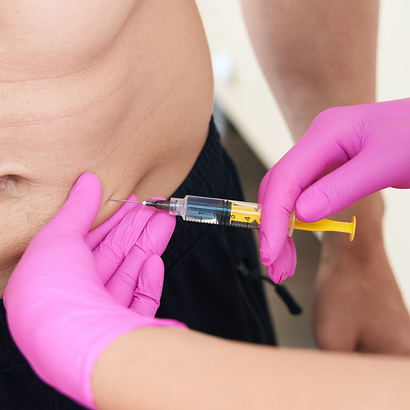 Aqualyx treatment being performed on a man's abdomen